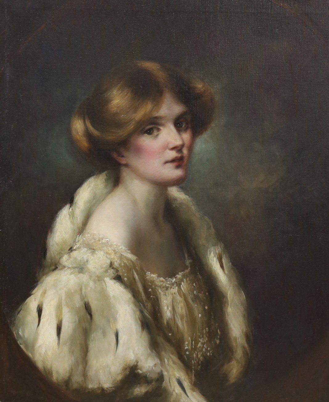 English School c.1900, oil on canvas, Portrait of a young lady wearing an ermine trimmed cape, painted to the oval, 77 x 64cm, unframed
